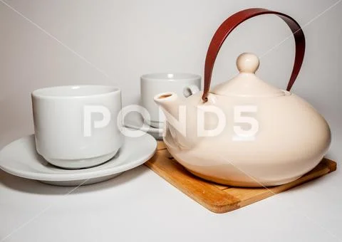 Teapot and mugs Stock Photos