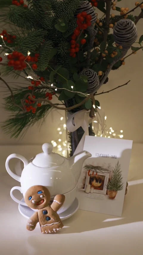 A teapot and a postcard close-up. Decorated christmas tree on background Stock Footage 224895500