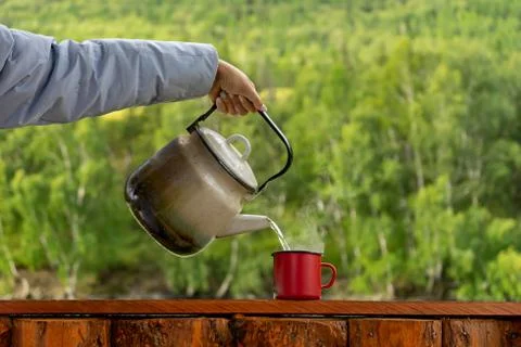 Teapot on the background of mountains Stock Photos