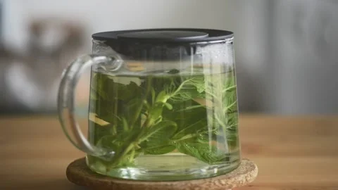 Teapot with brewing herbal mint tea rotation. Stock Footage 160832514