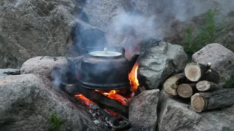 Teapot on campfires Stock Footage 11846925