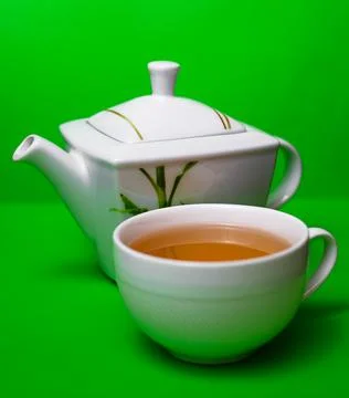 Teapot with a cup of tea Stock Photos