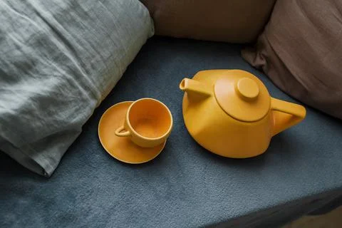 Teapot with cups on the sofa Stock Photos