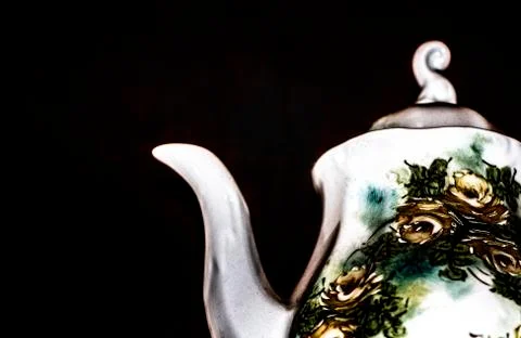 Teapot in a dark background Stock Photos