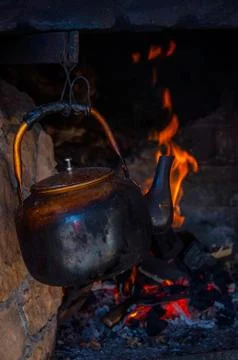 Teapot on the fire Stock Photos
