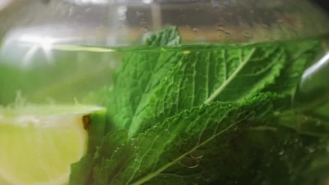 Teapot of fresh mint moroccan tea with lime, tea pot close up with pouring Stock Footage 266754579