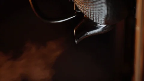 Teapot fuming with dark background Stock Footage 107177404