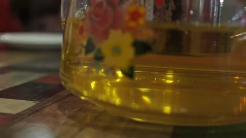 A teapot of green tea with a cup on the table Stock Footage 147270598