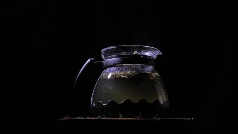 Teapot with a hot tea. Lemons dropped into a teapot. Stock Footage 83487164