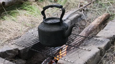Teapot Over the Fire is Boiling Water in Nature Stock Footage 252015221