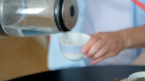 In the teapot pour boiling water to brew fragrant, delicious tea Stock Footage 127639904