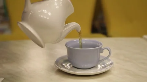 From a teapot pour tea in a mug Stock Footage 82054033