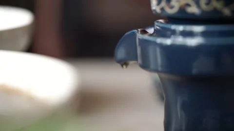 Teapot pouring tea into cup Stock Footage 261248611