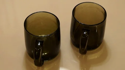 Teapot pouring tea into cup. Pouring tea Stock Footage 86507484