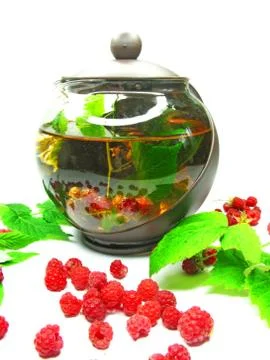 Teapot with raspberry berries Stock Photos