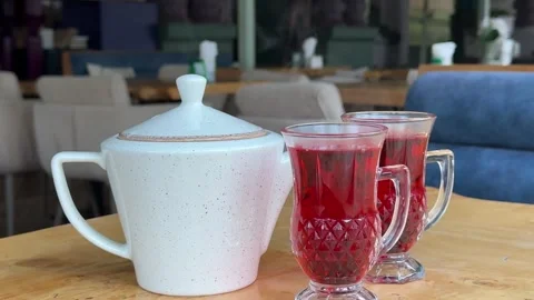 Teapot red drinks cup of tea on a table. Hot drink.Cup of tea with lemon and Stock Footage 322096203