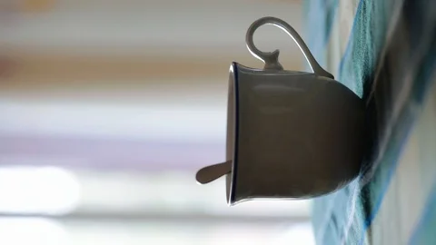 Teapot serving tea in a cup Stock Footage 107177399