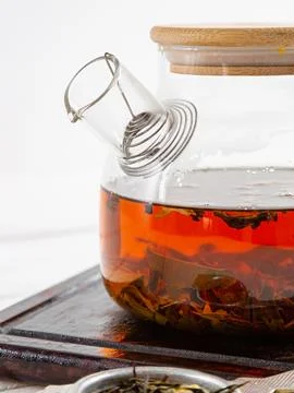 Teapot with tea on a white background. Stock Photos