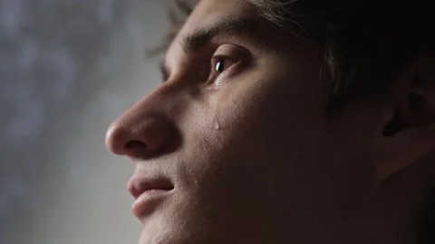 A tear rolls down the cheek of a young man, close-up Video stock 282482739