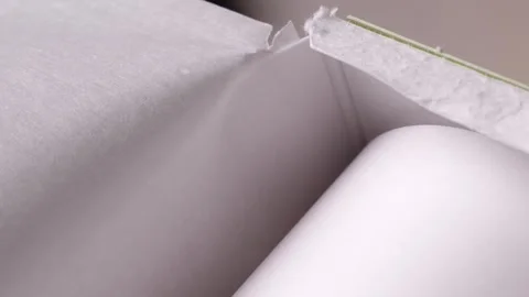 Tearing off baking paper in slow motion Stock Footage 310030470