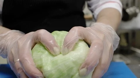 Tearing lettuce into small chunks during the preparation of Greek salad. Stock Footage 114889198