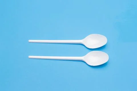 Teaspoon and plastic fork and glass tumbler Foto stock