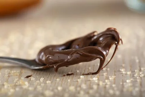 Teaspoon with chocolate spread and brown sugar Stock Photos