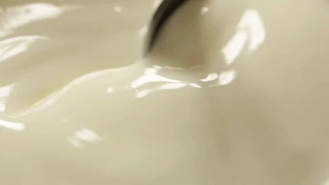 Teaspoon in creamy yogurt Stock Footage 74957987