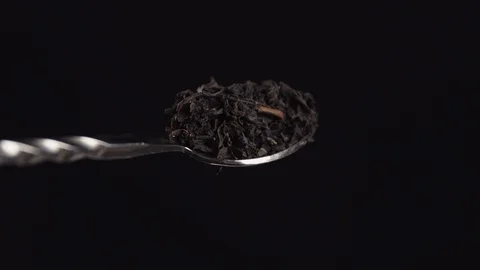 A teaspoon with crumbly tea rolls over Stock Footage 113081941