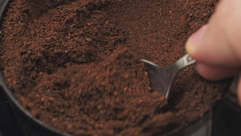 A teaspoon pours freshly ground coffee into a jar Stock Footage 129807582