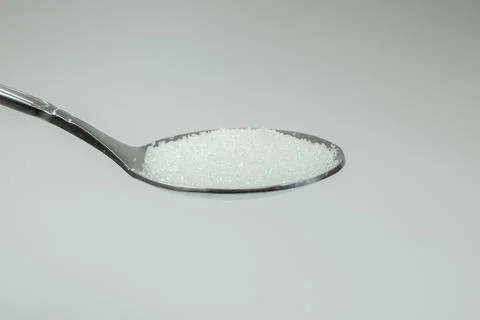 A teaspoon of sugar with a white background Foto stock