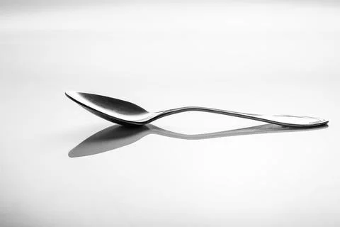Teaspoon top view with reflection isolated on white background Stock Photos