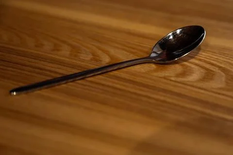 Teaspoon on a wooden table, in a cafe Stock Photos