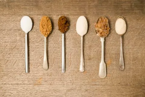 Teaspoons filled with sugar Stock Photos