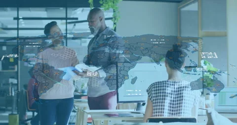 Tech analyst exchanging documents with team lead and activating data map overlay Stock Footage 310426197