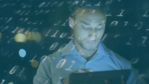 Tech analyst leaning over tablet, glow drawing focus, tapping, pausing and Stockbeeldmateriaal 333478036