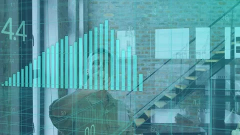 Tech analyst raising hand, shaping cyan hologram bar chart on glass while Stock Footage 334728765