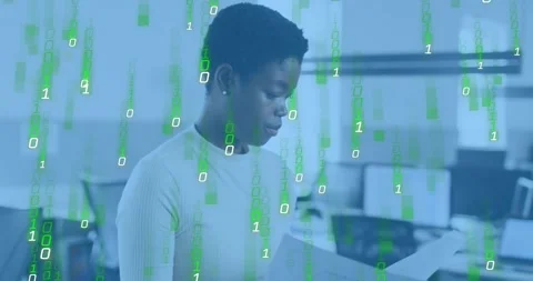 Tech analyst reading reports in office sparking green binary overlay enveloping Stock Footage 318047177