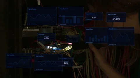 Tech approaching rack holding torch lighting fibers causing data panels probing Stock Footage 335404281