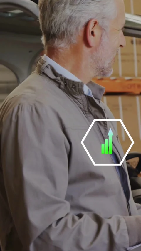 Tech in autoshop, hex overlay appearing on jacket, cycling bar chart wrench Stock Footage 334391243