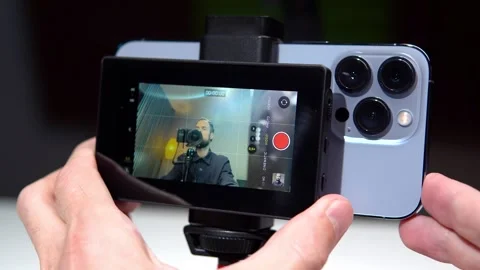 A tech blogger makes a video review on a smartphone and a screen broadcast Stock Footage 274401922