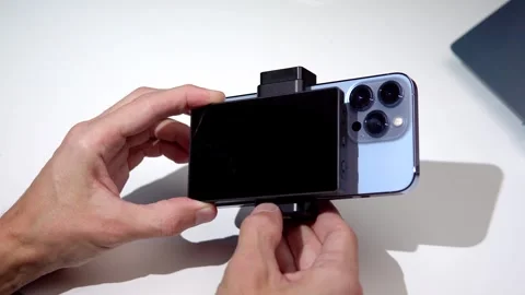 A tech blogger makes a video review on a smartphone and a screen broadcast Stock Footage 274402147