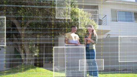 Tech carrying solar panel and woman tapping device on lawn, activating data Stock Footage 333873726