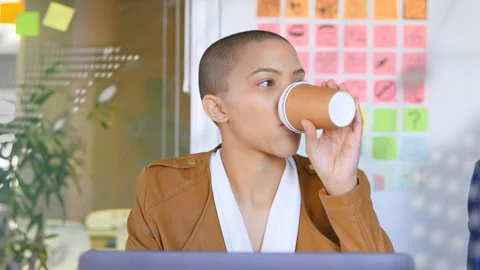 Tech code initiating overlay while developer sipping coffee focusing and Stock Footage 314848278