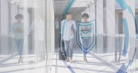 Tech colleagues wheeling suitcase, tapping smartphone, activating security Stock Footage 317275572