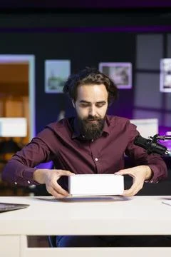 Tech content creator filming packaged product unboxing Foto stock
