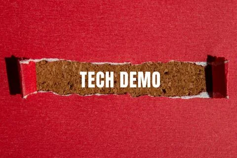 Tech Demo message written on ripped torn paper background. Conceptual Tech .. Stock Photos