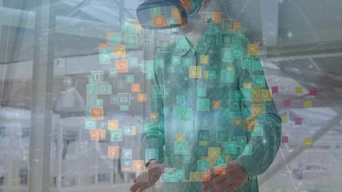 Tech designer raising hands as icon sphere appearing, donning VR headset and Stock Footage 333965845