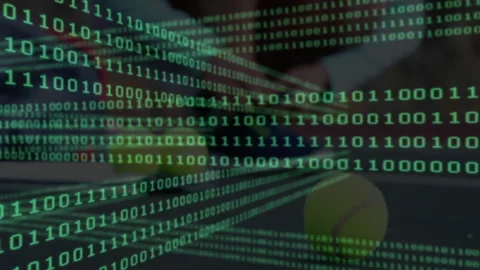 Tech designer working at office desk, analyzing floating green binary code over Stock Footage 307459393