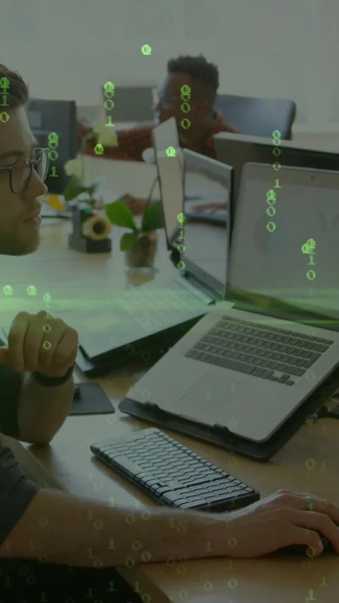 Tech developer after peer prompt, typing, updating charts as green code drifting Stock Footage 334319011